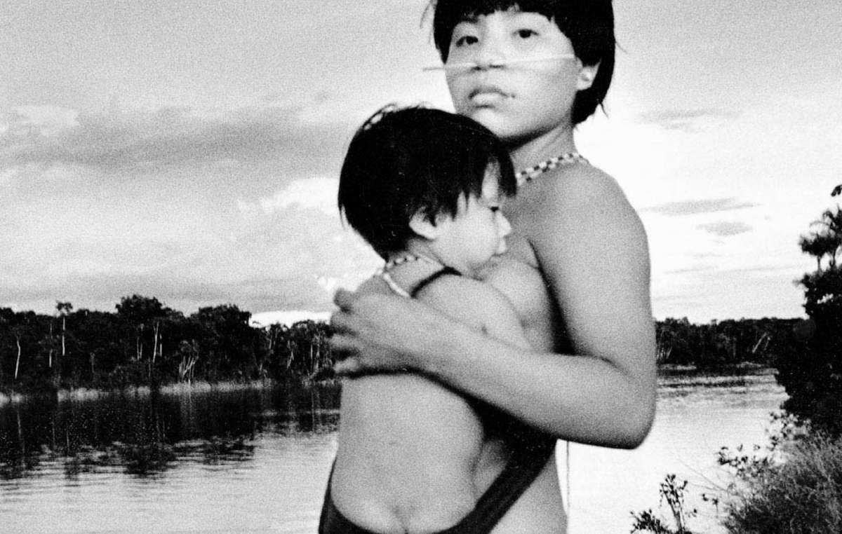 Yanomami mother and child alongside the river.