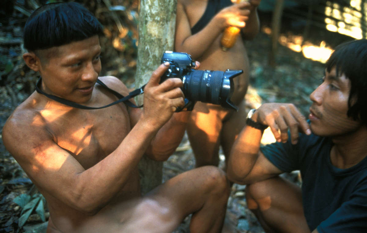 A Korubo man taking a photograph. This group of around 30 Korubo people were first contacted in 1996 by Sydney Possuelo, former head of the FUNAI unit. Their group had unknowingly migrated towards an area where armed loggers and colonists were invading and fearing for their safety, the FUNAI team decided to make contact with them.