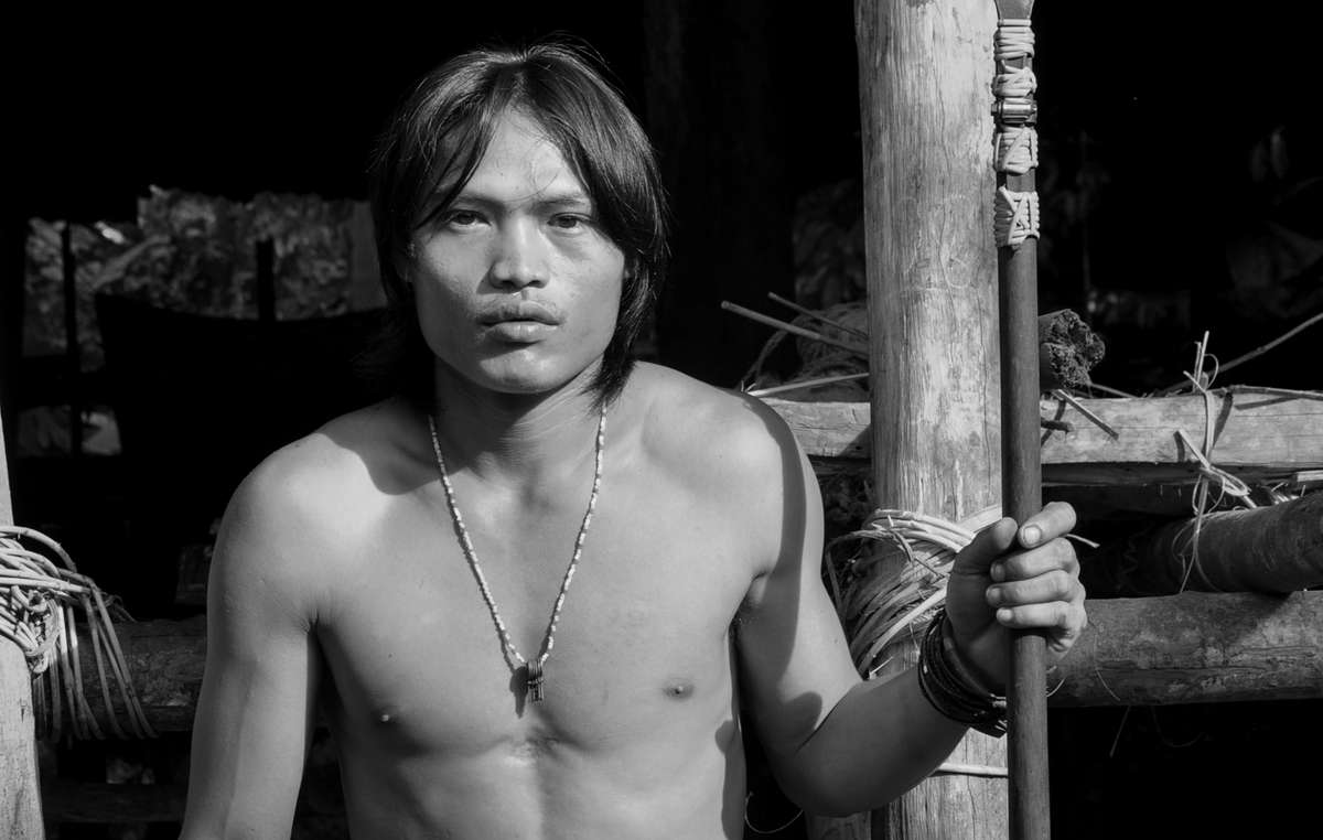Puiyun, a Penan man, holding a blowpipe (keleput)