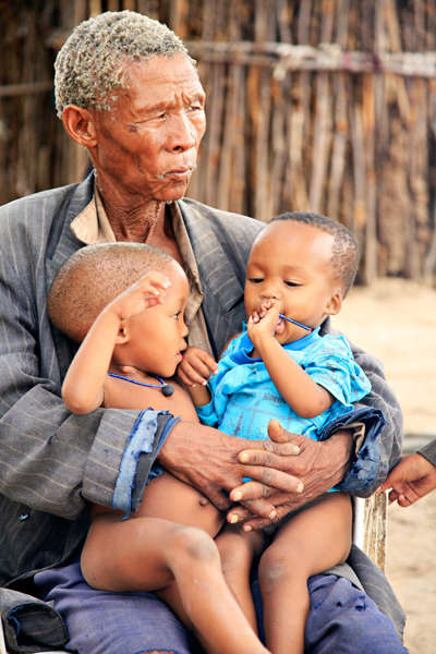 _Besa_, un chamane bushman, avec ses deux petits-fils.

Les Bushmen sont les plus anciens habitants de l’Afrique australe. Au cours des siècles, ce peuple nomade de chasseurs cueilleurs a été décimé par l’arrivée successive des Hottentos et des Bantous qui les ont repoussés vers des terres de plus en plus ingrates, dans le désert du Kalahari. Entre 1997 et 2002, de nombreux Bushmen ont été expulsés de leurs terres de la réserve de gibier du Kalahari central et déportés dans des camps de relocalisation situés en dehors de la réserve.

En réaction, les Bushmen intentèrent un procès au gouvernement botswanais et en 2006, avec le soutien de Survival International qui lança une campagne internationale en leur faveur, ils remportèrent une victoire historique en gagnant le droit de retourner chez eux. 

Cependant, d’autres communautés bushmen sont aujourd’hui menacées d’expulsion dans le cadre du projet de création d’un ‘corridor écologique’.

_Nous avons été créés comme le sable, nous sommes nés ici, dit un Bushman. Ce lieu est la terre du père du père de mon père_.