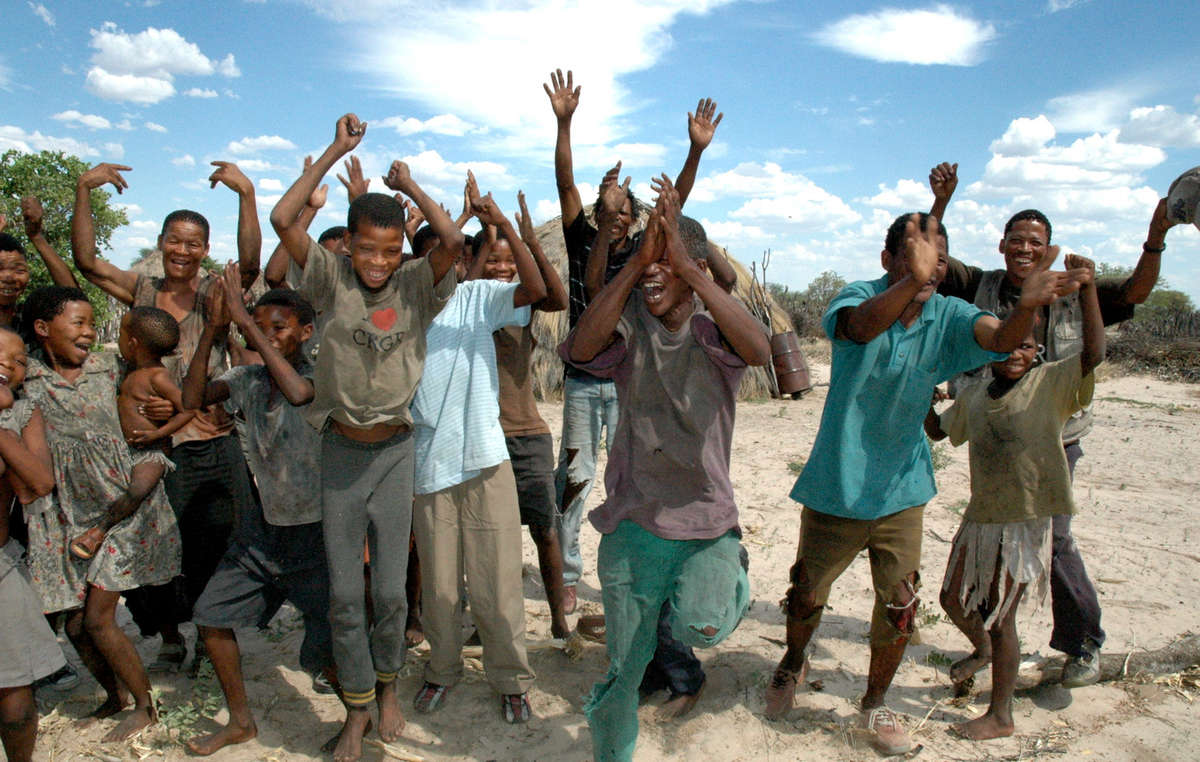 Kalahari Bushmen men celebrating in Metsiamenong after a victory in the court case against the Botswana government, December 2006. Botswana's Court of Appeal ruled that they should have access to a vital well on their ancestral land.