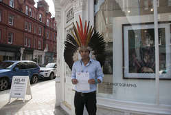 Amazon Indian Nixiwaka Yawanawá handed a letter to London's Atlas Gallery stating 'We are not passing away, we are struggling to survive.'
