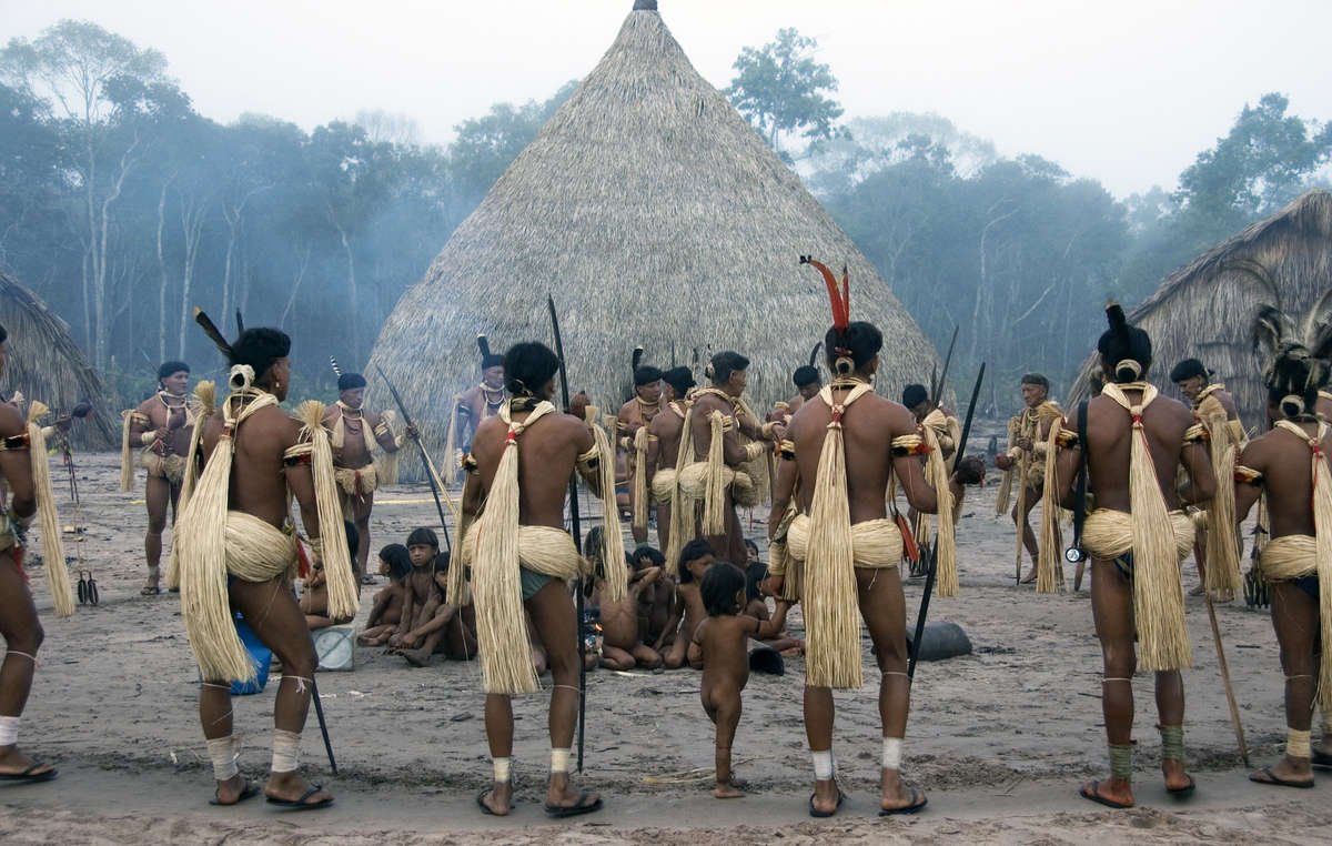 Enawene Nawe men perform the Yãkwa ritual, a four-month exchange of food between humans and the ancestral spirits, accompanied by dancing and chanting to the sound of flutes, Brazil.