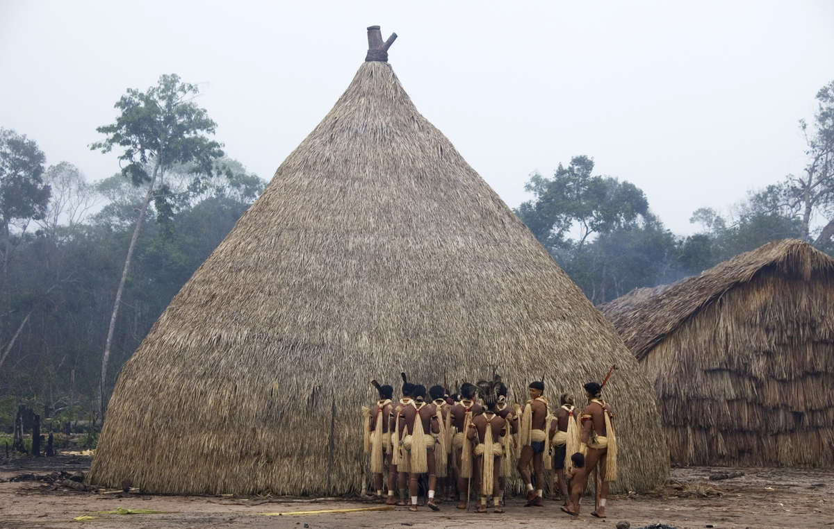 Enawene Nawe men perform the Yãkwa ritual, a four-month exchange of food between humans and the ancestral spirits, accompanied by dancing and chanting to the sound of flutes.